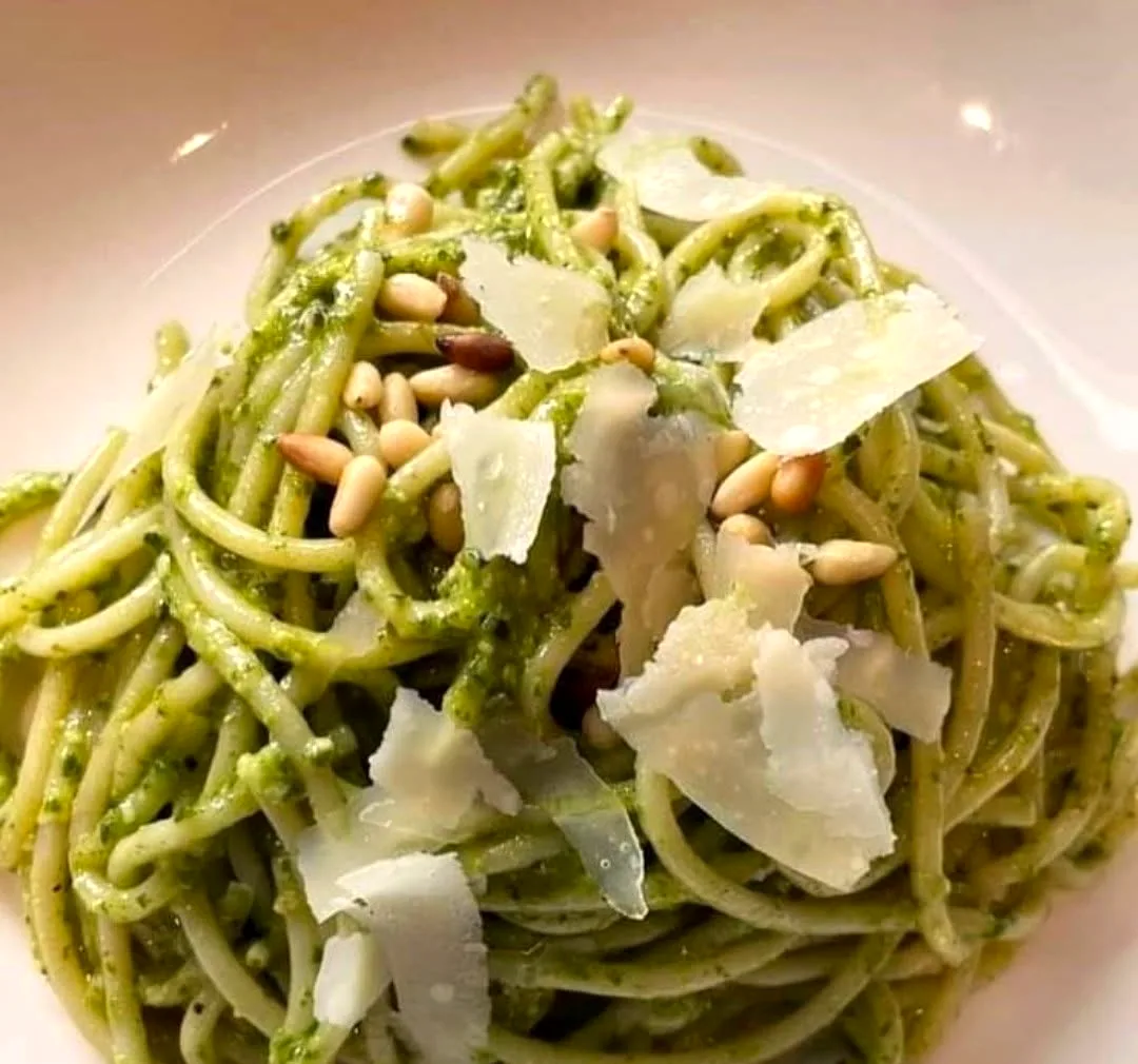 Pesto spaghetti with pine nuts and shaved parmigiano